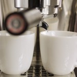 Two cups and espresso machine
