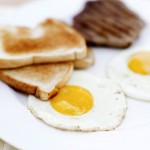 Two Fried Eggs Served with Steak and Toast